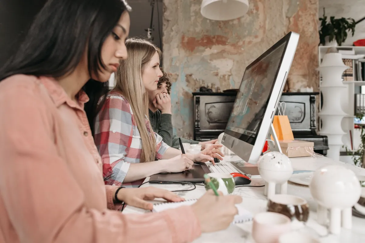 Team working together on laptops after a Microsoft 365 migration